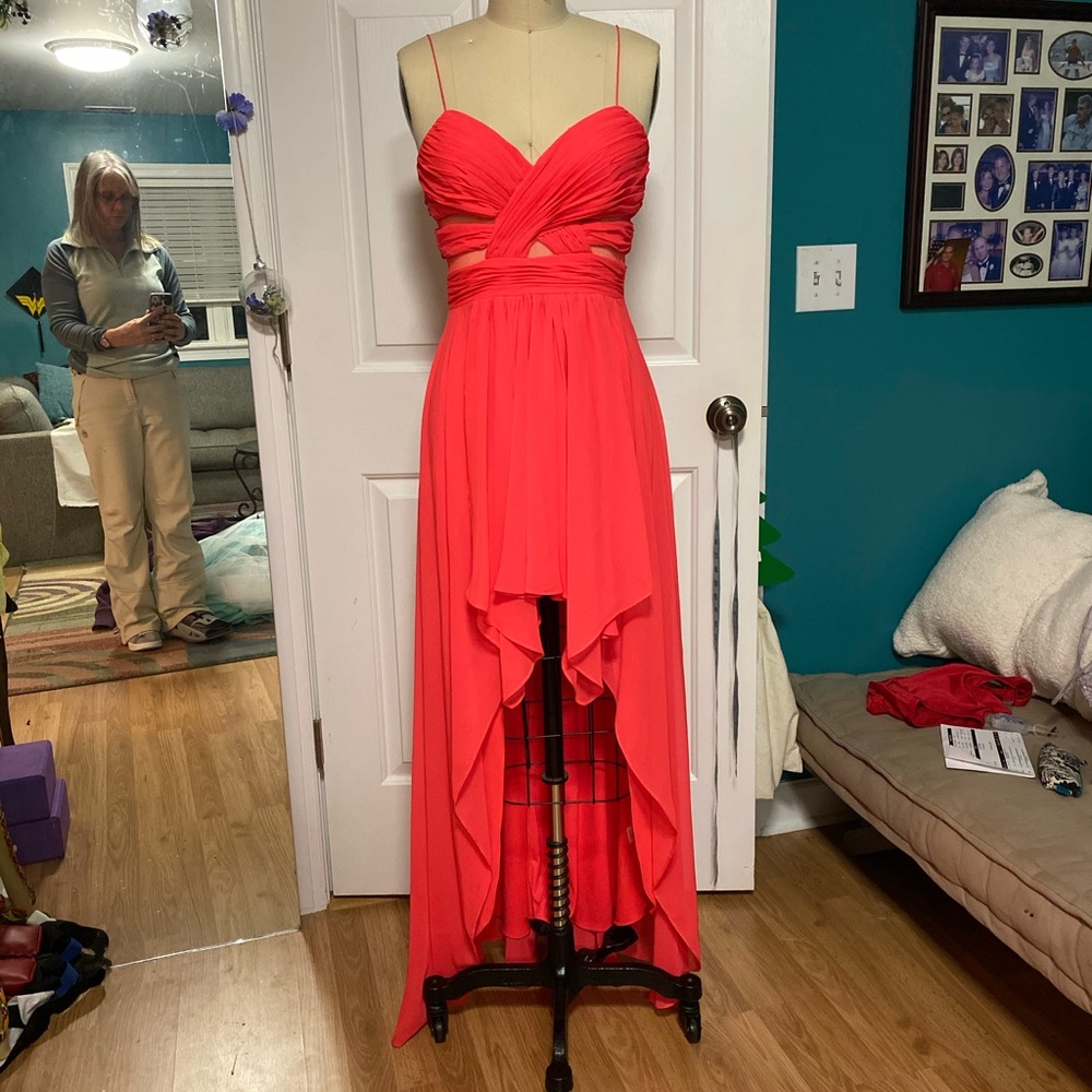 This dress is more of a coral color. It is not red! Deep neon coral. Very pretty